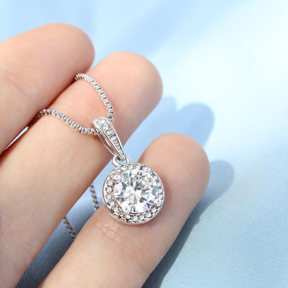 Eternal Home Necklace across woman's fingers