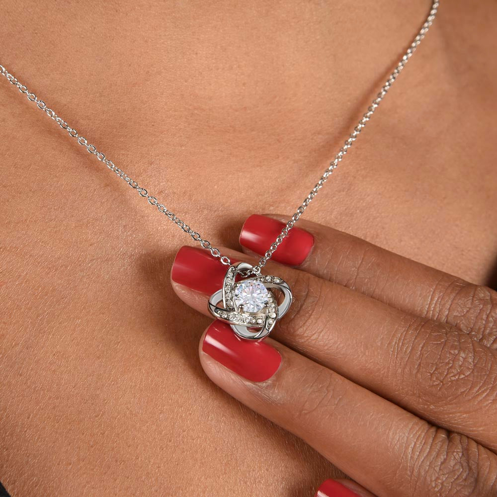 14K White Gold Finish Love Knot Necklace worn around a woman's neck