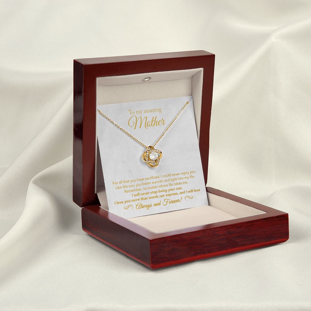 18K Yellow Gold Finish Love Knot Necklace open inside the mahogany style luxury gift box that is open with the LED light on