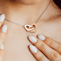 Interlocking Hearts Necklace Gift for daughter made of Polished Stainless Steel & Rose Gold Finish necklace around woman's neck