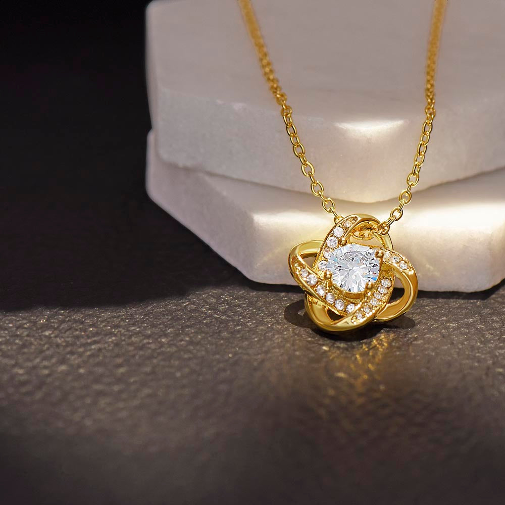 18K Yellow Gold Finish Love Knot Necklace on display