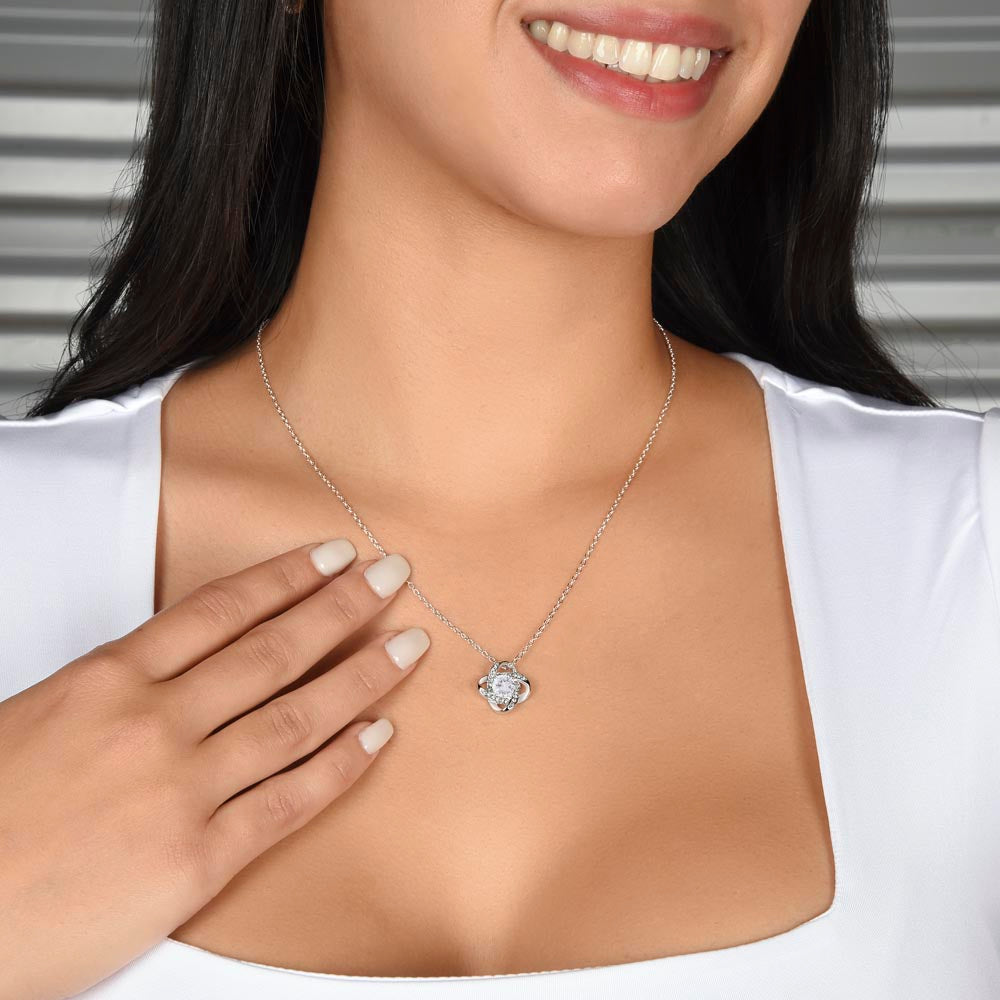 14K White Gold Finish Love Knot Necklace worn around a woman's neck